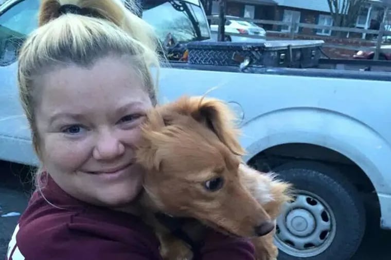 Ollie, who disappeared after fighting off an intruder at his owners' home Dec. 28, has been reunited with his owners, including Nicole Donlen, pictured. (Family photo)