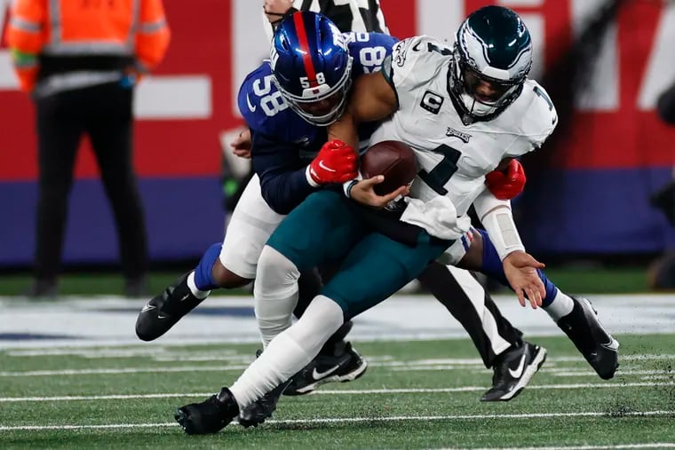 Eagles quarterback Jalen Hurts sacked by New York Giants linebacker Bobby Okereke in the second quarter at MetLife Stadium.