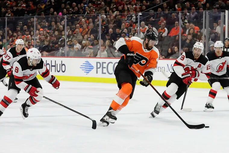 Flyers center Kevin Hayes skates with the puck against the New Jersey Devils on Feb. 6. Team will not be in training camps until at least July 10.