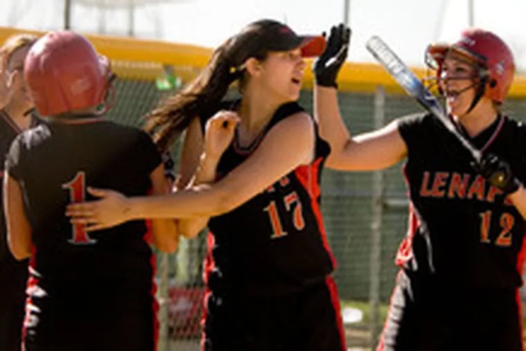 Lenape&#0039;s Hannah Moir (left) is congratulated by teammates Sue Schmidt (17) and Jaime Moir (12)after scoring the fifth run of the fourth inning. Hannah Moir batted in two of the runs with a double.