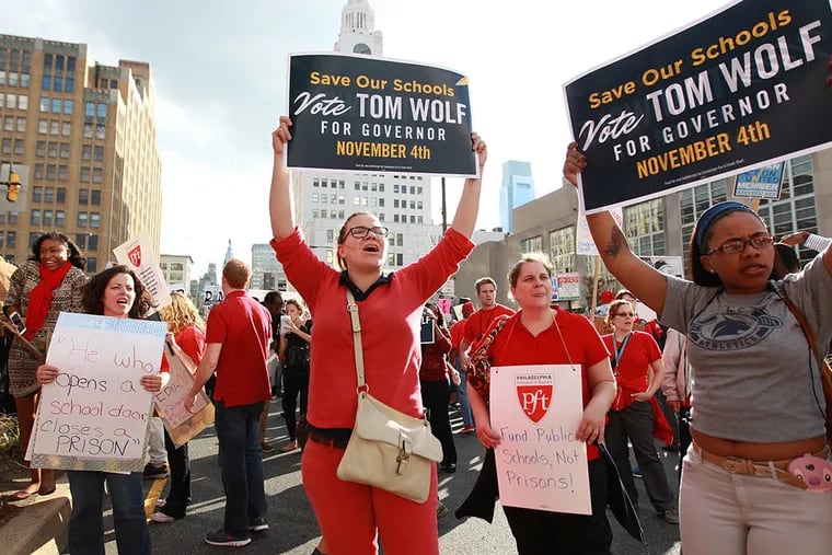 Jessica Downs, center, a teacher at Southwark elementary, joins hundreds of other teachers and protestors to cblock south bound Broad Street in front of the School District headquarters Thursday October 16, 2014. ( MICHAEL BRYANT  / Staff Photographer )