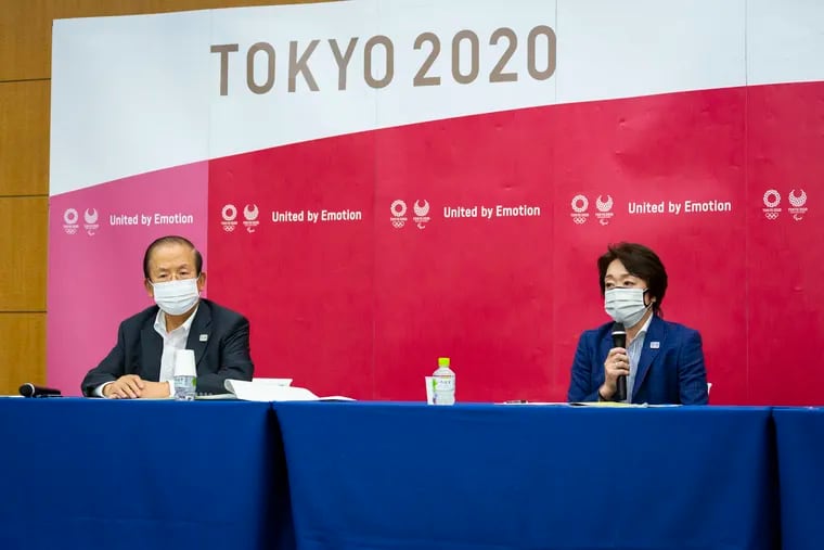 Tokyo 2020 CEO Toshiro Muto (left) and President Seiko Hashimoto at a news conference after receiving a report from a group of infectious-disease experts on Friday.