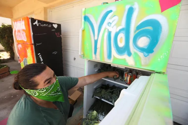 A project coordinator loads up a community refrigerator, a mutual aid effort, in Los Angeles in July 2020.