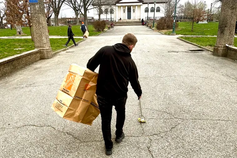 James Sherman, property manager with Savage Sisters, picks up trash in McPherson Square Park on Apr. 5, 2022, after their outreach to those fighting substance abuse. Many in the Kensington neighborhood are currently using xylazine, a powerful animal tranquilizer that has been increasing in the heroin and fentanyl supply in Philadelphia.