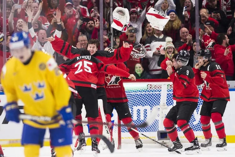 Canada goaltender —  and Flyers prospect —  Carter Hart (31) throws off his equipment and celebrates with teammates after the team's 3-1 win over Sweden during the title game of the IIHF world junior hockey championships on Friday in Buffalo. (Nathan Denette/The Canadian Press via AP)