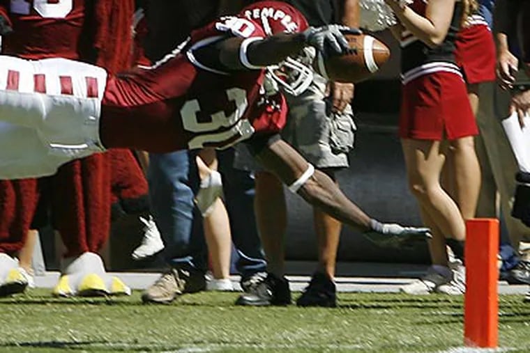 Bernard Pierce dives for one of his four touchdowns. (Michael S. Wirtz/Staff Photographer)