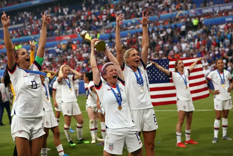 United States' Megan Rapinoe, center, holds the trophy as she celebrates with teammates after they defeated the Netherlands 2-0 in the Women's World Cup final soccer match at the Stade de Lyon in Decines, outside Lyon, France, Sunday, July 7, 2019. Rapinoe has been outspoken in demanding equal pay for the U.S. Women's National Team.