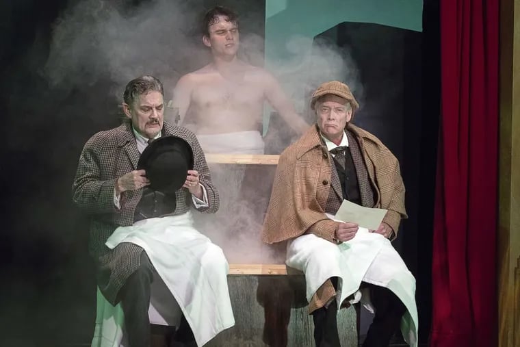 (Left to right:) Watson (Carl N. Wallnau), and Sherlock Holmes (Greg Wood) discover Sir Henry Baskerville (Jacob Dresch) in a steam bath in the Pennsylvania Shakespeare Festival’s production of “The Hound of the Baskervilles.”