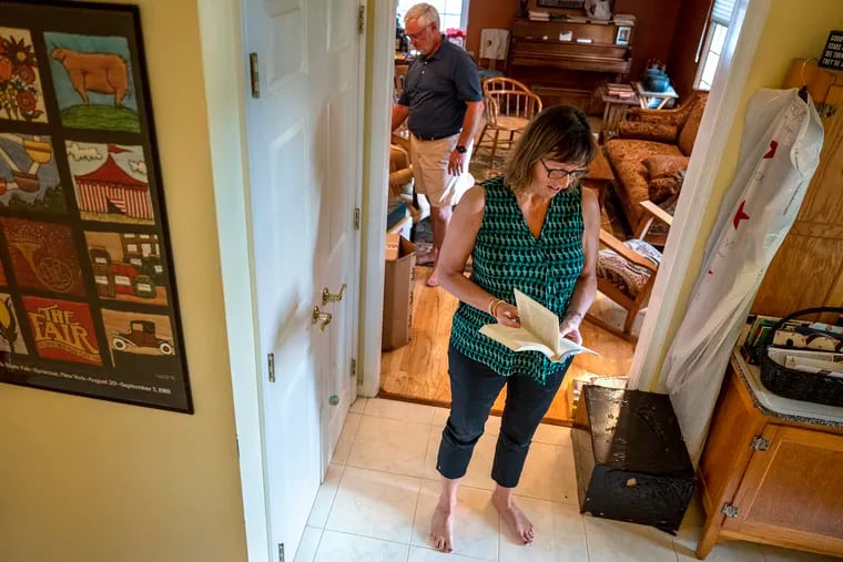 Christina Kimball-Kelly reads from a favorite Virginia Woolf book that belonging to her son, with husband John Kelly at their Springfield, Delaware County, home on Sept. 15, 2021. The couple wants to give their son's belongings to an Afghan family setting its first shallow roots in the U.S.