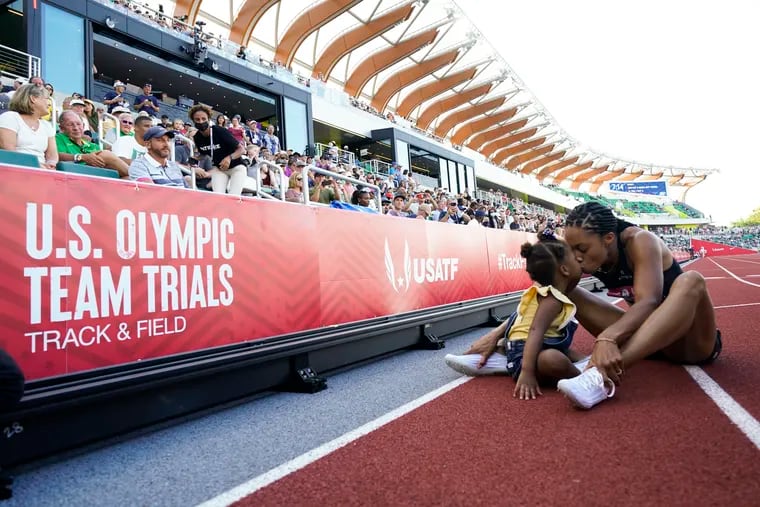 American track star Allyson Felix, right, kisses her daughter Camryn at the U.S. Olympic Track and Field trials last month.