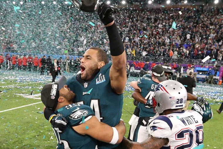 Eagles linebackers Mychal Kendricks and Kamu Grugier-Hill celebrate after winning Super Bowl LII in Minneapolis Sunday.