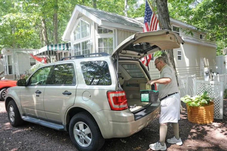 At Avalon Campground in North Clermont, Jules Carcanague prepares some items for a yard sale in Ocean City. He and his companion of 20 years, Vicki O’Connell, live in the campground for 3.5 months of the year and spend the rest of the time in Florida.