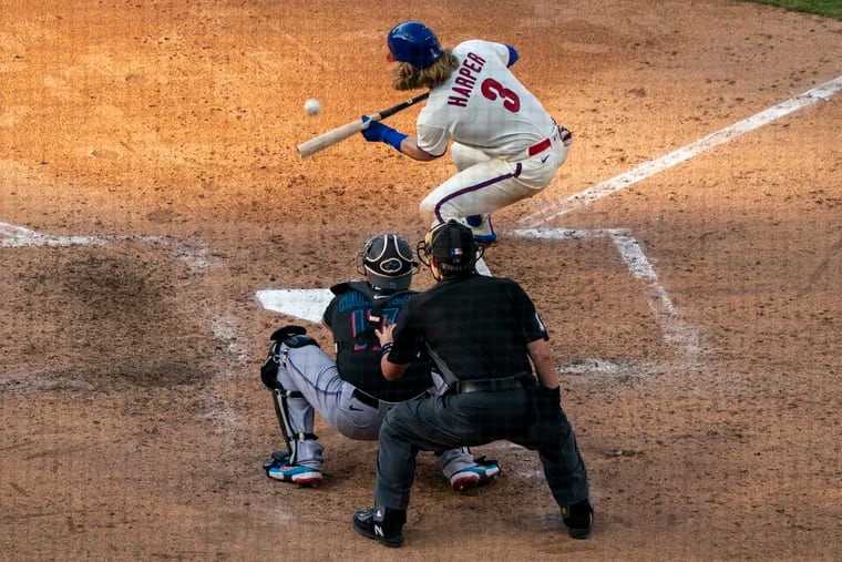 Bryce Harper lays down a bunt against the Miami Marlins.