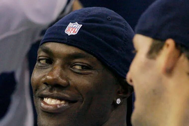 The preseason was still a good time to smile, and Terrell Owens (left) did so while on the bench with Tony Romo.