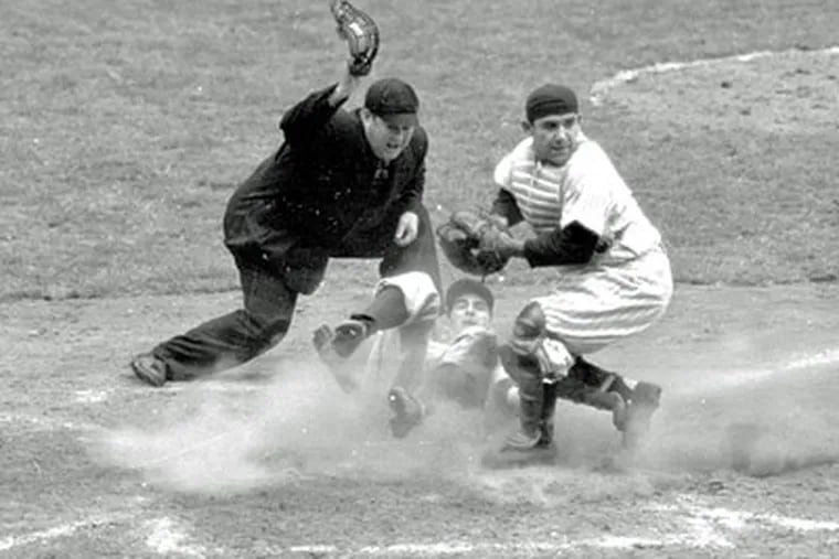 In this Oct. 6, 1950, file photo, then-Phillies shortstop Granny Hamner is tagged at the plate by New York Yankees catcher Yogi Berra as he tries to score from third in the ninth inning of Game 3 of the World Series, at Yankee Stadium in New York. The Yankees won 3-2. (AP Photo / File)