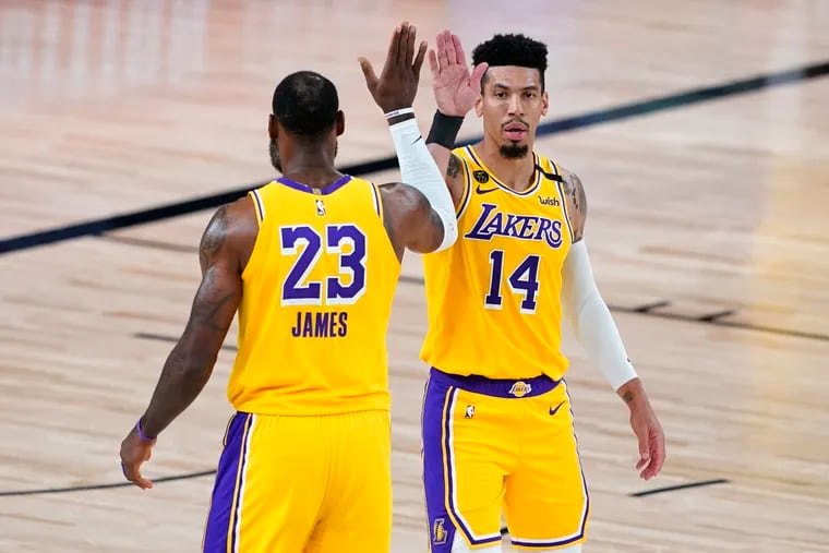 Los Angeles Lakers' LeBron James (23) and former Laker Danny Green (14) celebrate after a play against the Portland Trail Blazers during the first half of an NBA basketball first round playoff game on Aug. 29.
