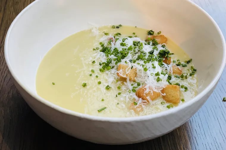 The Winter Warmth soup at the Love is a lighter, modern take on classic potato leek soup, served here with thyme-scented garlic cream and delicate brioche croutons.