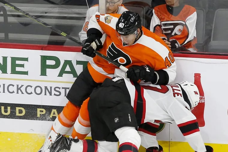 Flyers forward Corban Knight goes after the puck after knocking down New Jersey's John Quenneville during the third-period in a preseason game at the PPL Center in Allentown.