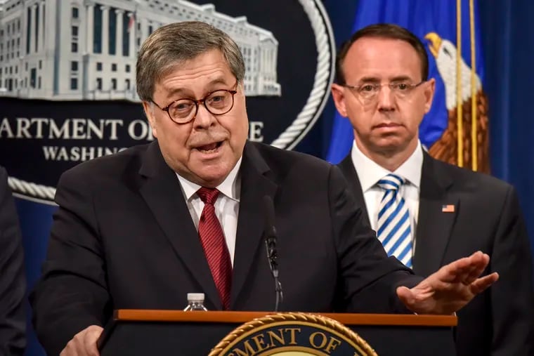 Attorney General William Barr, left, answers a question during a press conference hours before releasing a version of the Mueller report, on Apri 18, 2019 in Washington. Deputy Attorney General Rod Rosenstein is behind him at right.