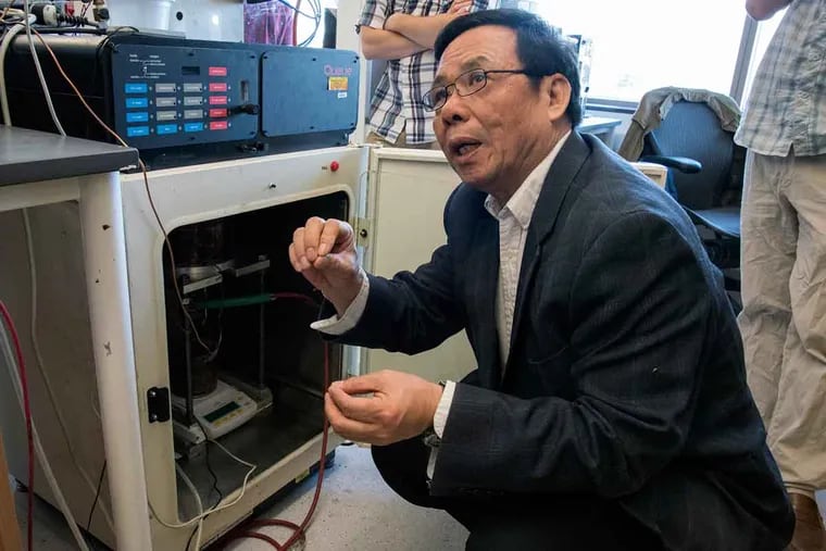 Rongjia Tao, a Temple University physicist, explains the method to reduce the amount of fat in chocolate by using an electric field to reduce viscosity during production at Temple's Science Education and Research Center.