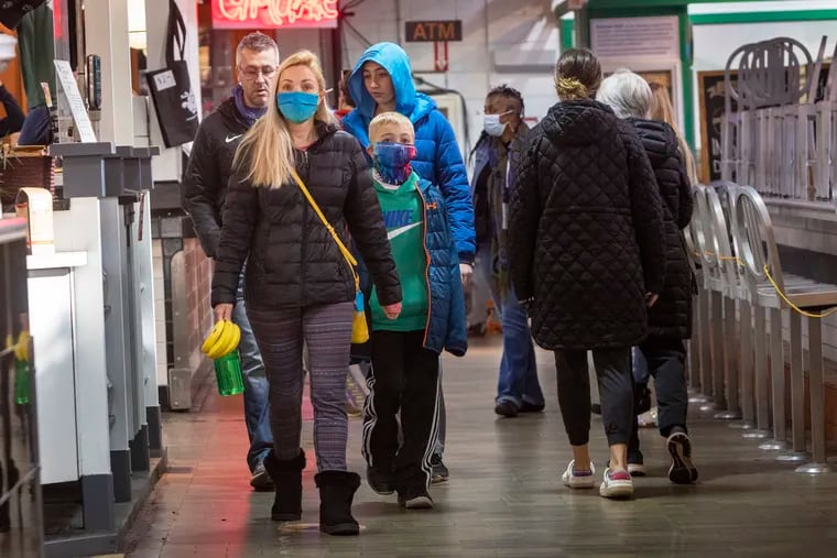 Patrons of Reading Terminal Market on Monday morning reflect ambivalence over indoor masking.