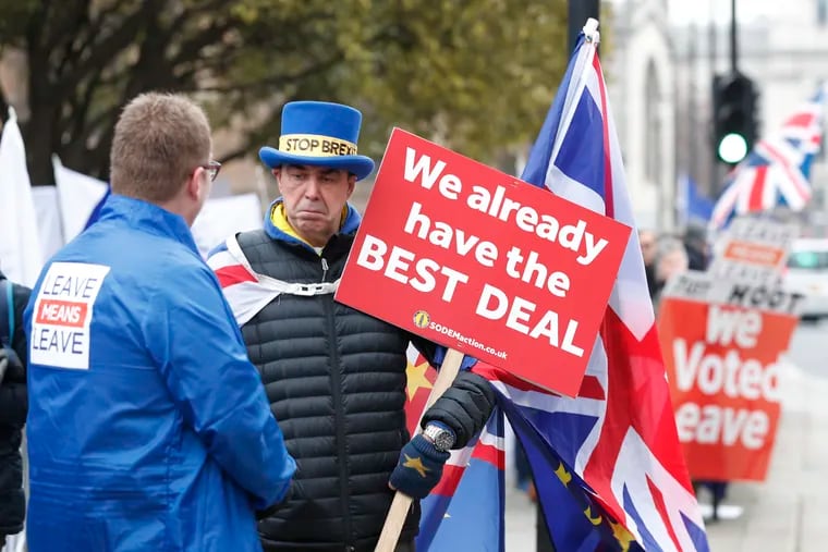 Pro-Brexit (left) and anti-Brexit (right) protesters debate their views outside parliament in London last week.