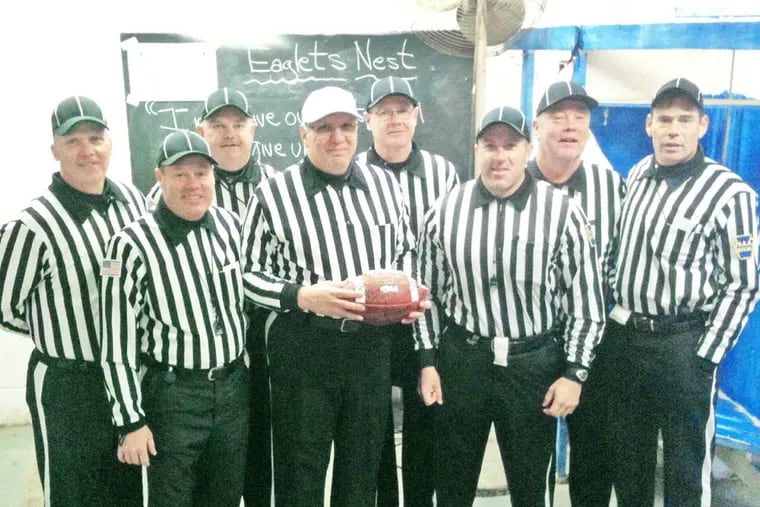 The officiating crew at George Washington-Archbishop Ryan game (from left): Dan Ferry, Mark Brunkel, Frank Powers, Mark Warner (holding football), Frank McAnulty, Anthony Bocchicchio, Dave Parfitt and Dave Decker.