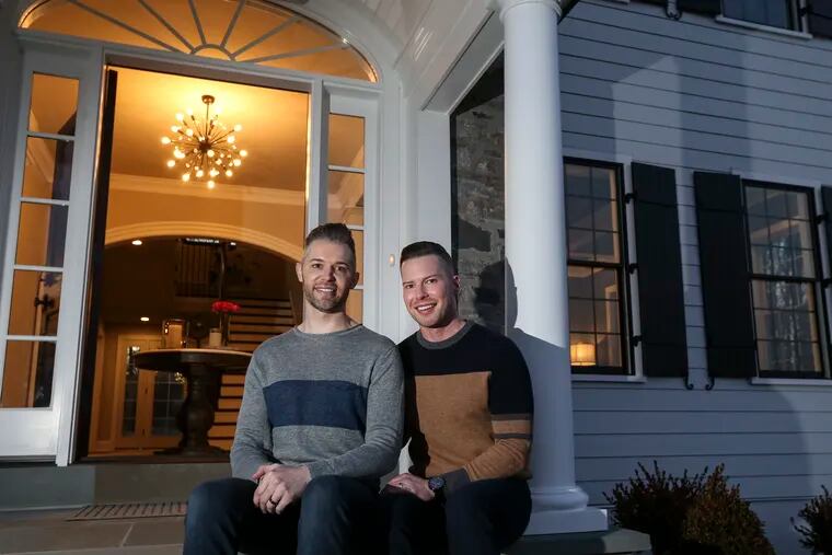 Jimmy Steele (right) and his husband, Waylon, chose a starburst chandelier to make a fun statement in the foyer of their newly built home in Malvern.
