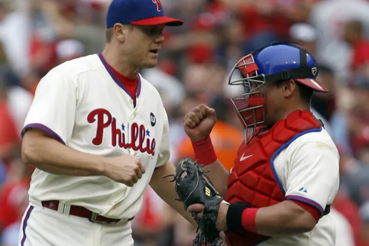 Jonathan Papelbon and Carlos Ruiz celebrate the Phillies' 2-1 win over the Orioles to snap a nine-game losing streak. (Yong Kim/Staff Photographer)