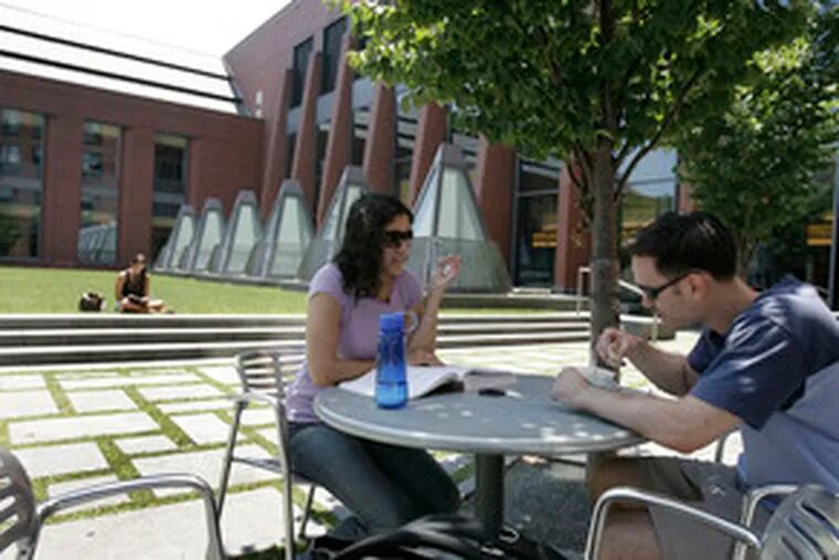 Wharton School student David Lebel, 27, lunches with his fiance, Eva Marwaha, at the Huntsman Hall courtyard. The 126-year-old school is part of the University of Pennsylvania.