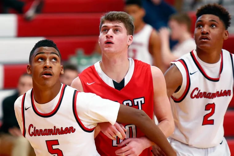 The eyes of (from left) Cinnaminson’s Ahmad Gantt, Cherry Hill East’s Jake Bernstein and Cinnaminson’s Chad Howard are on a free throw in the first quarter during the Coney Classic basketball tournament Saturday, Jan. 27, 2018, at Rancocas Valley. Cinnaminson went on to win, 56-49. LOU RABITO / Staff