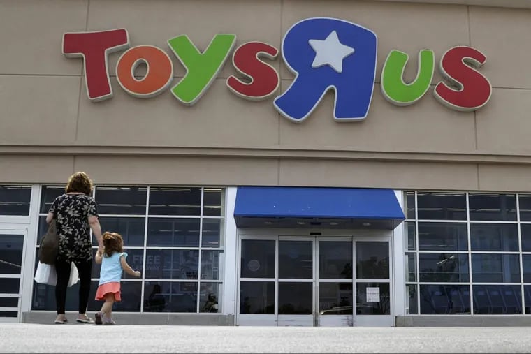FILE – In this Sept. 19, 2017, file photo, shoppers walk into a Toys R Us store, in San Antonio. Toys R Us says it will be closing some U.S. stores and converting others to cobranded locations as it continues to deal with its financial restructuring following its bankruptcy filing.