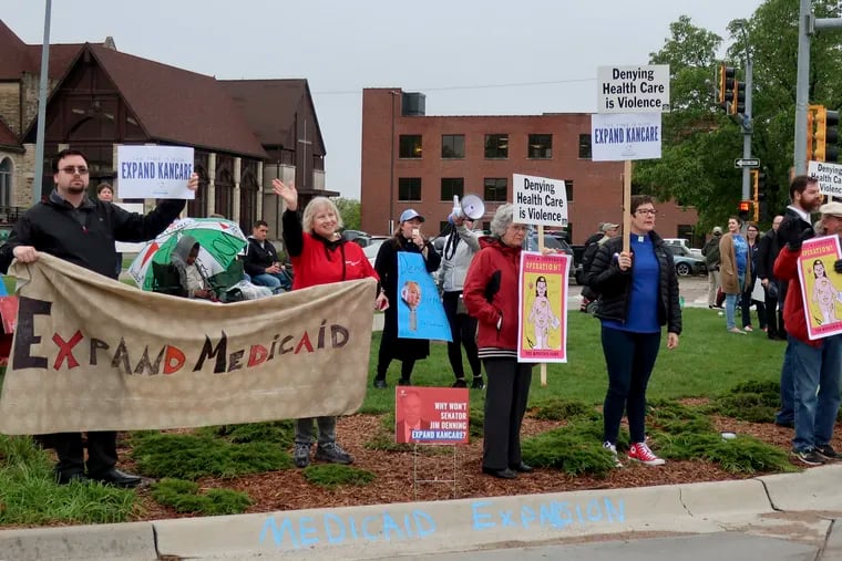 Advocates for expanding Medicaid in Kansas stage a protest outside the entrance to the state house last month in Topeka. Supporters are trying to get an expansion plan through the Republican-controlled Senate over the objections of its conservative leaders. (AP Photo/John Hanna)