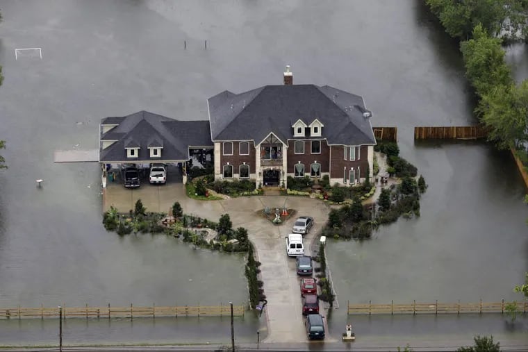 A house in Houston is surrounded by floodwaters from Harvey on Tuesday.