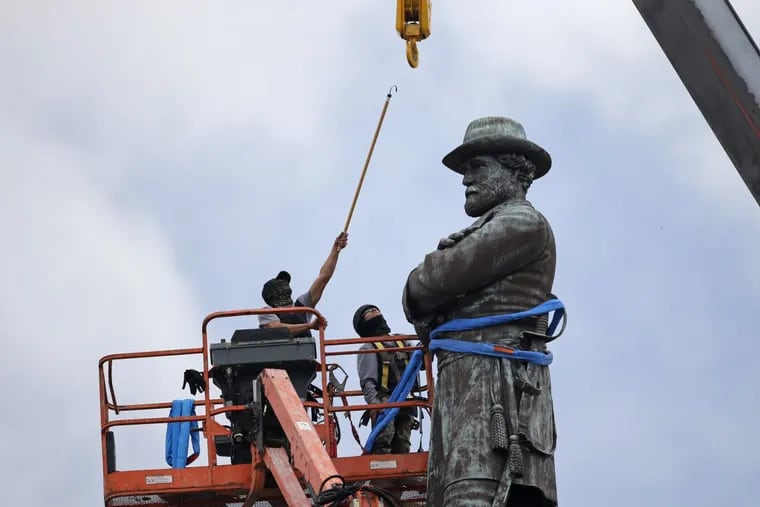 Workers prepare to take down the statue of former confederate general Robert E. Lee, which stands over 100 feet tall, in Lee Circle in New Orleans, Friday, May 19, 2017. (AP Photo/Gerald Herbert)