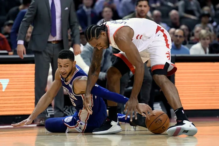 Ben Simmons (left) and the Raptors' Kawhi Leonard battle for the ball during the Sixers' loss to Toronto in October.