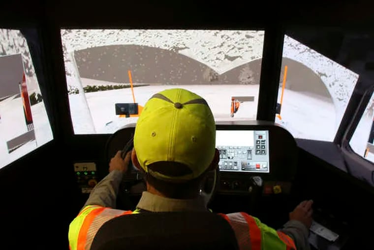 Terence Mundt operates a snowplow simulator during a class in Plano, Texas.