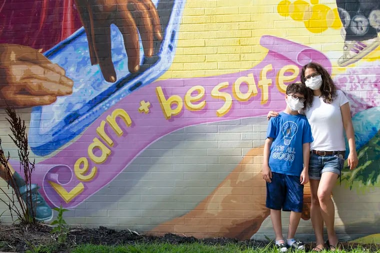 Haleh Rabizadeh Resnick and her son Josh Resnick at a mural at a nearby school on Tuesday.  Her other child declined to be in the photograph.  Josh will be entering 7th grade with in person classes in the fall.