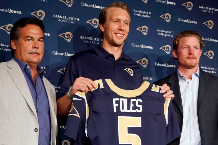 Nick Foles holds up his new St. Louis Rams jersey between coach Jeff Fisher (left) and GM Les Snead. Foles was obtained from the Eagles for Sam Bradford.