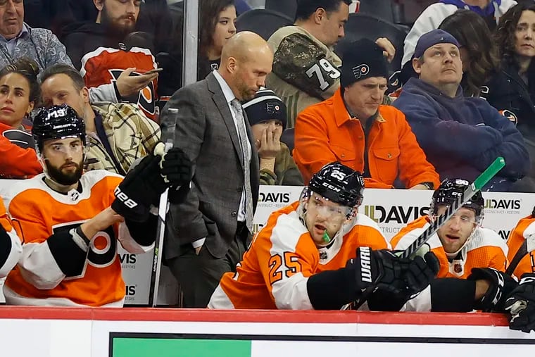 Flyers Interim coach Mike Yeo walking the bench against the Minnesota Wild on March 3.