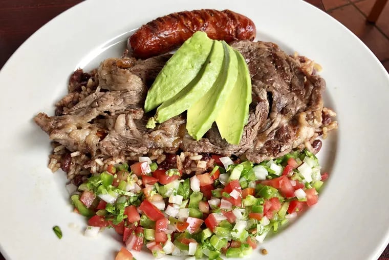 The Churrasco Salvadoreno from El Bocado at 1005 E. Passyunk Avenue. features grilled rib-eye steak over rice and beans with Salvadoran salsa.