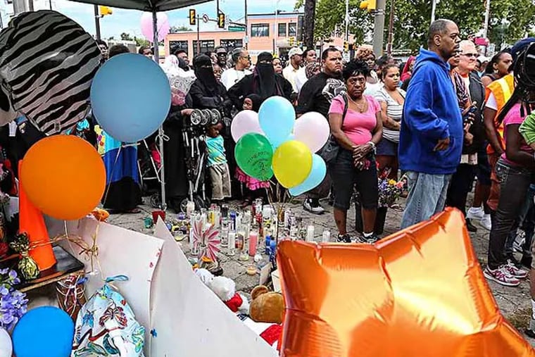 A vigil was held Tuesday at Germantown and Allegheny Avenues, scene of the crash July 25 that took the lives of three children. (Steven M. Falk / Staff Photographer)