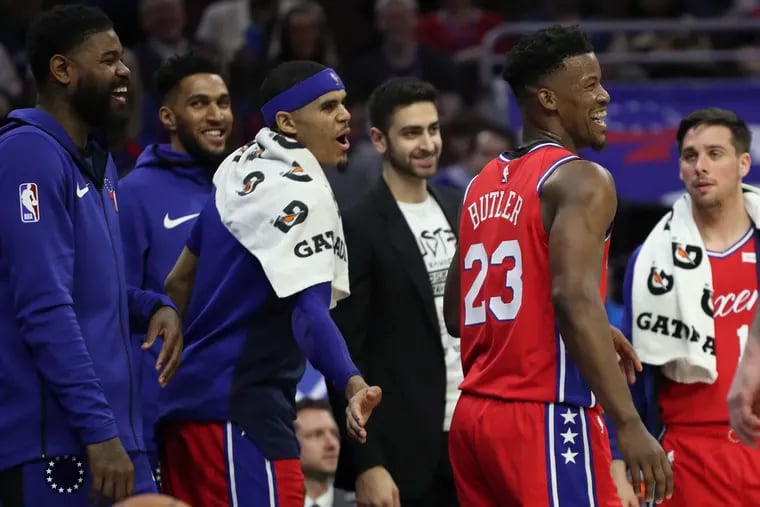 Sixers forward Jimmy Butler laughs with his teammates after a failed dunk attempt after the whistle in the second quarter of a game against the Sacramento Kings at the Wells Fargo Center in Philadelphia on Friday, March 15, 2019.