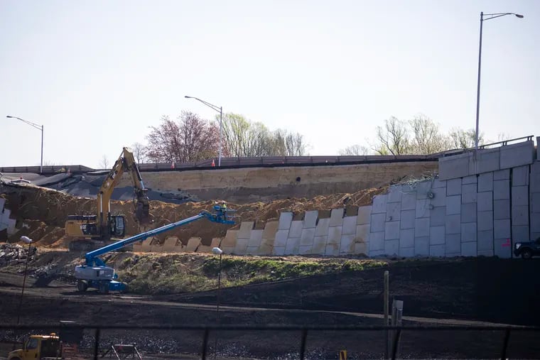 Crews cleaning up a collapsed retaining wall on I-295 in Bellmawr in early April. The collapse could increase the length and (so far) $900 million cost of the project to untangle the highway's congested and dangerous interchange with I-76 and Route 42.