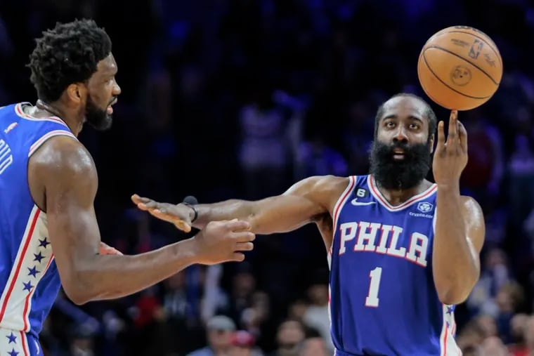 Sixers James Harden tries to keep Joel Embiid away while he spins the ball on his finger as the clock winds down against the New Orleans Pelicans during the fourth quarter at the Wells Fargo Center on Monday. Sixers beat the Pelicans 120-111