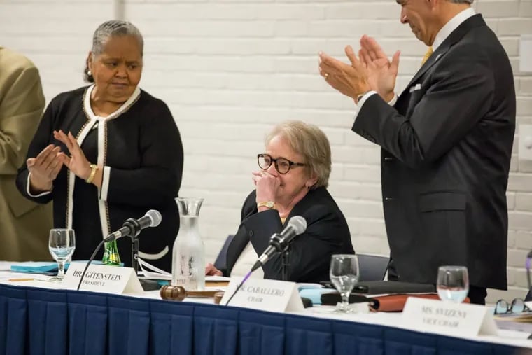 Trustees of the College of New Jersey applaud R. Barbara Gitenstein at a Tuesday board meeting after her announcement that she plans to retire as president at the end of the 2017-18 school year.