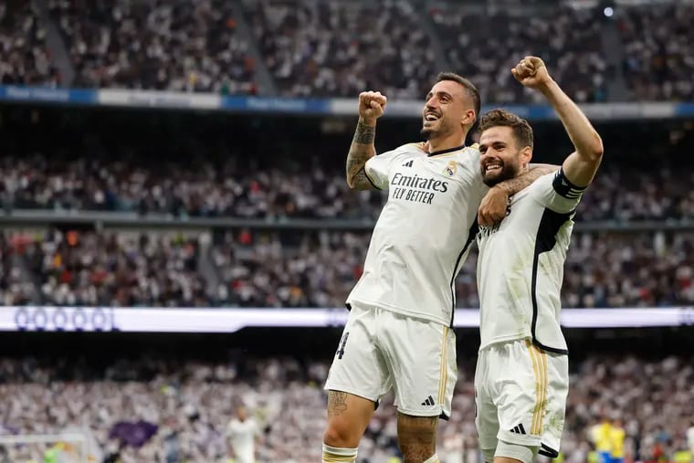 Real Madrid's Spanish forward #14 Joselu (L) celebrates scoring his team's third goal, with Real Madrid's Spanish defender #06 Nacho Fernandez, during the Spanish league football match between Real Madrid CF and Cadiz CF at the Santiago Bernabeu stadium in Madrid on May 4, 2024. (Photo by OSCAR DEL POZO/AFP via Getty Images)