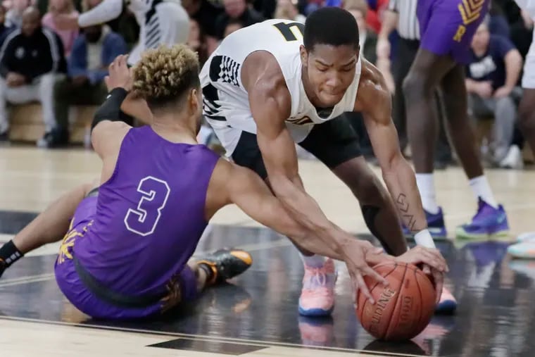 Archbishop Wood’s Jaylen Stinson (right) and Roman Catholic's Lynn Greer (No. 3) battle for a loose ball in Sunday's Philadelphia Catholic League game. Archbishop Wood won 94-93 in double overtime.
