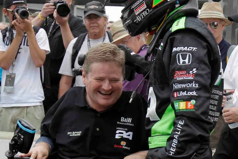 Car owner Sam Schmidt (left) laughs with driver Townsend Bell on the opening day of time trials for the Indianapolis 500.