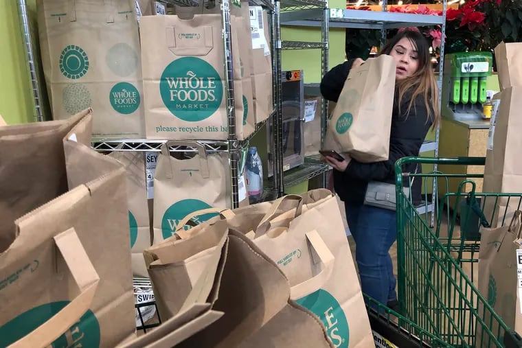 Alid Alvarado picks up orders for Instacart customers at a Whole Foods in the Chicago area.